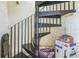 Spiral staircase with black metal railings and steps, showcasing its unique design at 6310 Cecelia Dr, New Port Richey, FL 34653