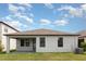 Spacious backyard featuring a covered patio, manicured lawn, and home exterior at 13209 Haystack Ct, Riverview, FL 33579