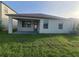 View of the backyard, featuring a covered patio and well-maintained lawn at 13209 Haystack Ct, Riverview, FL 33579