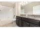 Bathroom featuring a double vanity with granite countertop and cabinets, a white tile tub and a shower at 13209 Haystack Ct, Riverview, FL 33579