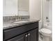 Bathroom showcasing granite countertop, dark wood cabinets, and shower/tub combo at 13209 Haystack Ct, Riverview, FL 33579