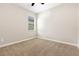 A cozy carpeted bedroom with natural lighting from a window at 13209 Haystack Ct, Riverview, FL 33579