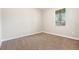 Bright, carpeted bedroom featuring neutral walls and a window for natural light at 13209 Haystack Ct, Riverview, FL 33579