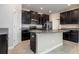 Modern kitchen featuring dark cabinets, granite countertops, stainless steel appliances, and a center island with a sink at 13209 Haystack Ct, Riverview, FL 33579