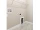 A small laundry room with tile flooring, shelf, hookups and white trim at 13209 Haystack Ct, Riverview, FL 33579