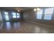 Bright living room with tile flooring, large windows, and a glass door to the backyard at 13209 Haystack Ct, Riverview, FL 33579