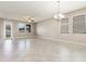 Bright, airy living room features tile flooring, a ceiling fan, and three large windows at 13209 Haystack Ct, Riverview, FL 33579