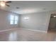 Spacious living room with tile flooring, two windows, and an elegant light fixture at 13209 Haystack Ct, Riverview, FL 33579
