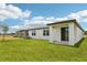 Well-maintained backyard with a lush lawn and a covered patio area, perfect for outdoor entertaining at 1732 Brekey Way, Zephyrhills, FL 33541