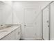 Bathroom featuring dual sinks with granite countertops and a glass-enclosed shower at 1732 Brekey Way, Zephyrhills, FL 33541