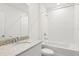 Bathroom featuring a vanity with a granite countertop and a shower-tub combination at 1732 Brekey Way, Zephyrhills, FL 33541
