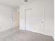 A cozy bedroom featuring neutral carpeting and a closet with sliding doors at 1732 Brekey Way, Zephyrhills, FL 33541