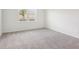 Clean and airy bedroom featuring carpeted flooring and a bright window at 1732 Brekey Way, Zephyrhills, FL 33541