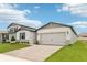Beautiful home featuring a paved driveway leading to a two-car garage and modern stone accents at 1732 Brekey Way, Zephyrhills, FL 33541