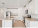 Modern kitchen featuring white cabinets, stainless steel appliances, and granite countertops at 1732 Brekey Way, Zephyrhills, FL 33541