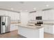 Modern kitchen featuring white cabinets, stainless steel appliances, and a large island with granite countertops at 1732 Brekey Way, Zephyrhills, FL 33541