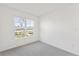 Bright, modern bedroom with neutral carpet, white walls, and a window view at 17330 Alderwood Ln, Punta Gorda, FL 33982
