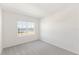 Bright, modern bedroom with large window, neutral carpet, and white walls at 17330 Alderwood Ln, Punta Gorda, FL 33982