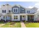 Attractive townhome with blue and gray exterior, covered porch, and well-maintained landscaping at 17330 Alderwood Ln, Punta Gorda, FL 33982