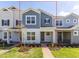 Attractive townhome with blue and gray exterior, covered porch, and well-maintained landscaping at 17330 Alderwood Ln, Punta Gorda, FL 33982