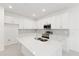 Bright, modern kitchen with white cabinets, quartz countertops, stainless steel appliances, and tile backsplash at 17330 Alderwood Ln, Punta Gorda, FL 33982