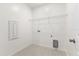 Simple laundry room with tiled floor, wire rack, and laundry hookups at 17330 Alderwood Ln, Punta Gorda, FL 33982