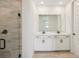 Modern bathroom featuring double vanity and tiled walk-in shower at 1775 Draughton Dr, Zephyrhills, FL 33541