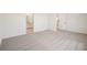 Spacious bedroom featuring plush carpeting and a large window for natural light at 1775 Draughton Dr, Zephyrhills, FL 33541