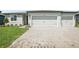 Charming home featuring a paved driveway and attached two-car garage at 1775 Draughton Dr, Zephyrhills, FL 33541
