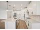 Well-lit kitchen featuring white cabinets, stainless steel appliances, and a center island at 1775 Draughton Dr, Zephyrhills, FL 33541