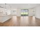 Bright living room with wood-style flooring and sliding glass doors to backyard at 1775 Draughton Dr, Zephyrhills, FL 33541