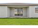 Covered patio overlooks a well-maintained lawn and a glimpse of the surrounding neighborhood at 1775 Draughton Dr, Zephyrhills, FL 33541