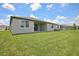 Large grassy backyard with a covered patio, perfect for outdoor entertaining at 1806 Draughton Dr, Zephyrhills, FL 33541