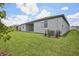 Exterior view of a freshly mowed backyard on a sunny day, with a view of the home at 1806 Draughton Dr, Zephyrhills, FL 33541
