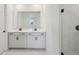 Sleek bathroom with double sinks, modern fixtures, and a walk-in shower at 1806 Draughton Dr, Zephyrhills, FL 33541