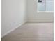 Minimalist bedroom with light wood floors, a window with privacy tint, and a serene atmosphere at 1806 Draughton Dr, Zephyrhills, FL 33541