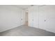 Cozy bedroom with neutral carpet, a double door closet, and a crisp, white interior at 1806 Draughton Dr, Zephyrhills, FL 33541