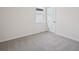 Bright bedroom with neutral carpet, a large window with natural light, and minimalist decor at 1806 Draughton Dr, Zephyrhills, FL 33541
