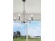 Stylish chandelier hanging in front of a scenic window view of a home at 1806 Draughton Dr, Zephyrhills, FL 33541