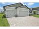 Spacious two-car garage with a paved driveway at 1806 Draughton Dr, Zephyrhills, FL 33541