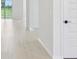 Bright hallway with neutral wood flooring at 1806 Draughton Dr, Zephyrhills, FL 33541