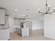 Modern kitchen featuring gray cabinets, stainless steel appliances, and a center island with quartz countertops at 1806 Draughton Dr, Zephyrhills, FL 33541