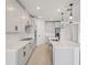 Bright kitchen featuring white cabinets, stainless steel appliances, and a center island with a sink at 1806 Draughton Dr, Zephyrhills, FL 33541