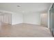 Empty living room with neutral paint, modern lighting, and light-colored flooring at 1806 Draughton Dr, Zephyrhills, FL 33541