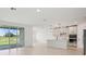 Bright and open floor plan with a modern kitchen, and large sliding glass doors with a lake view at 1806 Draughton Dr, Zephyrhills, FL 33541