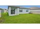 A spacious backyard with lush green grass and a sliding door leading to the interior at 1817 Draughton Dr, Zephyrhills, FL 33541