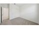 Carpeted bedroom featuring neutral walls and a closet with folding doors for practical storage at 1817 Draughton Dr, Zephyrhills, FL 33541