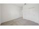 Clean bedroom with neutral carpeting, white walls and closet with folding doors for optimized storage at 1817 Draughton Dr, Zephyrhills, FL 33541