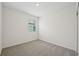 Neutral bedroom featuring carpet flooring and a window at 1817 Draughton Dr, Zephyrhills, FL 33541