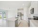 Bright modern kitchen features a center island, stainless steel appliances, and white cabinets at 1817 Draughton Dr, Zephyrhills, FL 33541